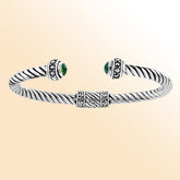 Handcrafted silver cuff bracelet with green quartz stones in twisted rope Bali design.